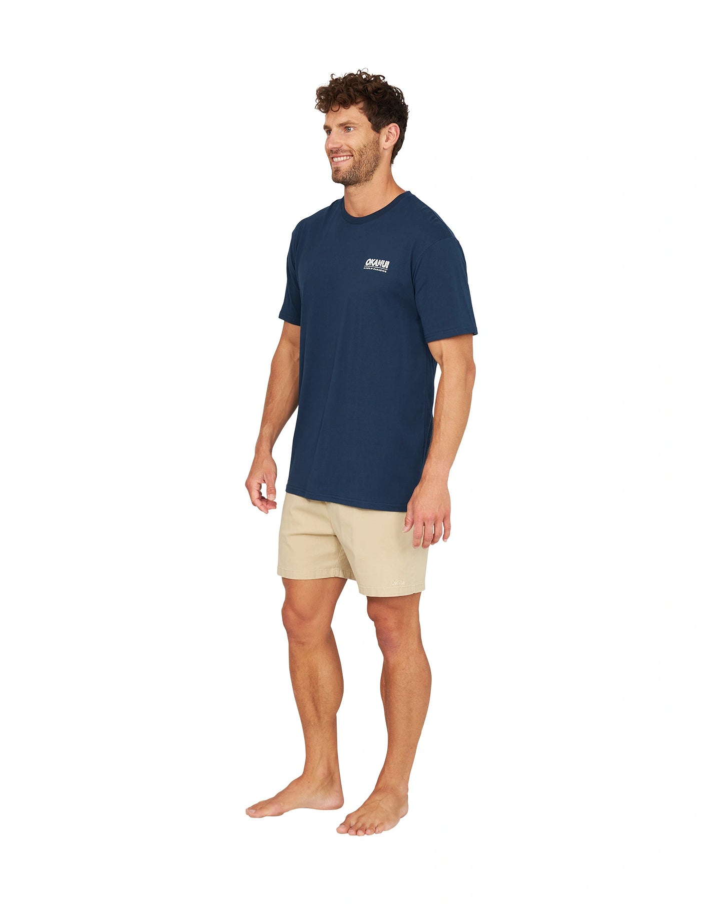 Full front slightly side view of a male model wearing the Okanui OG Baggies T-Shirt in navy.