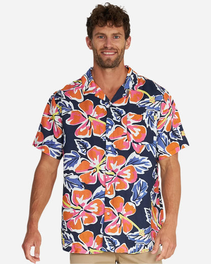 A male model wearing the Okanui Rhapsody Aloha Short Sleeve Shirt in navy multi.