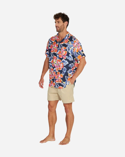 Full body view of a male model wearing the Okanui Rhapsody Aloha Short Sleeve Shirt in navy multi.