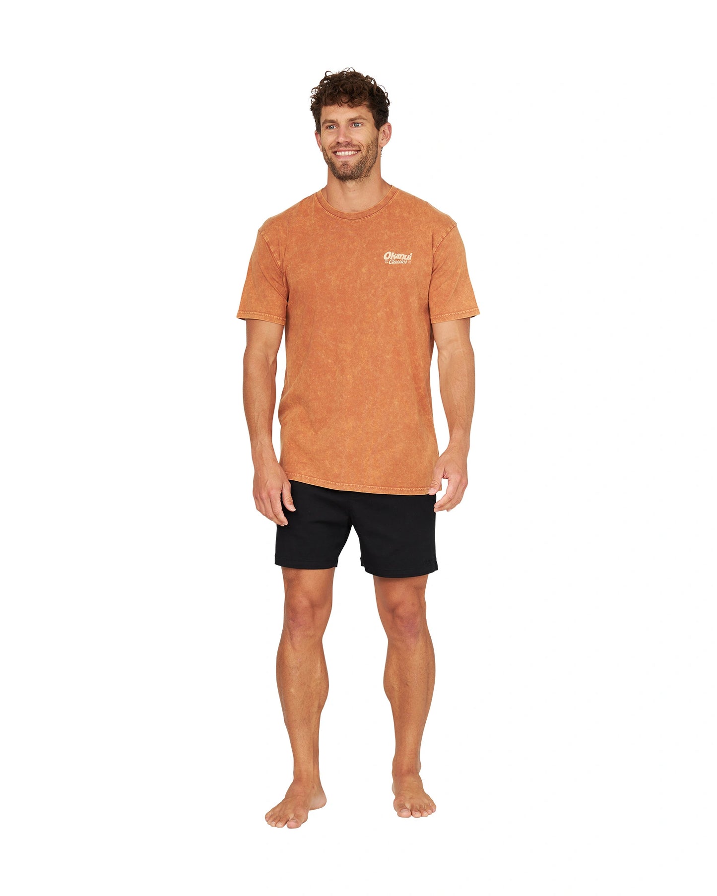 Full front view of a male model wearing the Okanui Big Screen T-Shirt in rust color.