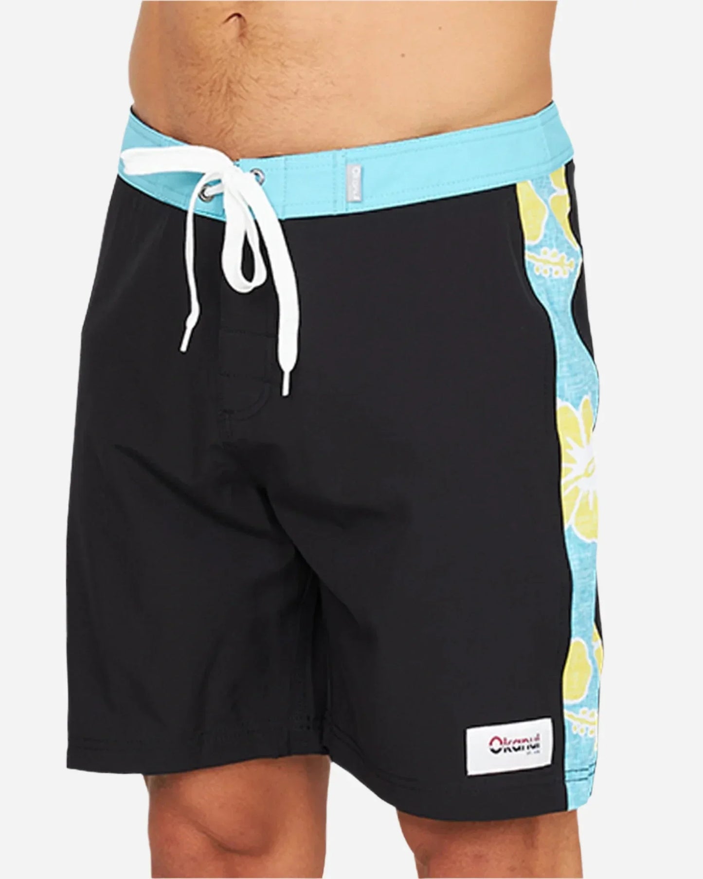 Okanui Sidelines Boardrider Boardshort in Black in a close front view featuring the patch logo on the left leg and white drawcord with velcro fly and fix waist.