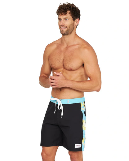 A shirtless male model wearing the Okanui Sidelines Boardrider Boardshort in Black