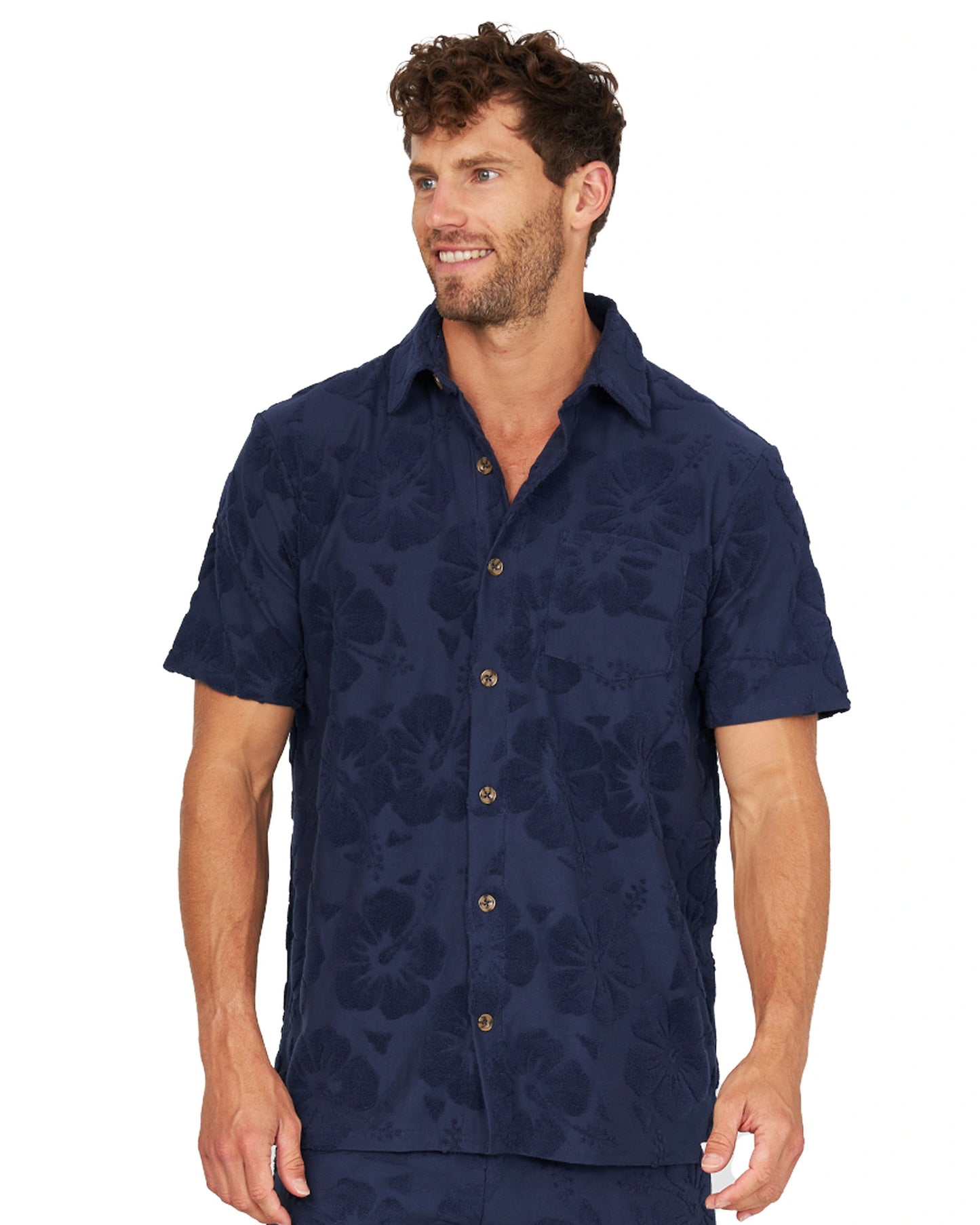 A male model wearing the Okanui Terry Jacquard Shirt in Hibiscus Navy.