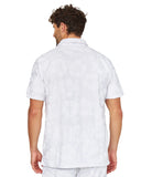 Closer back view of a male model wearing the Okanui Starboard Short Sleeve Shirt in Hibiscus white.