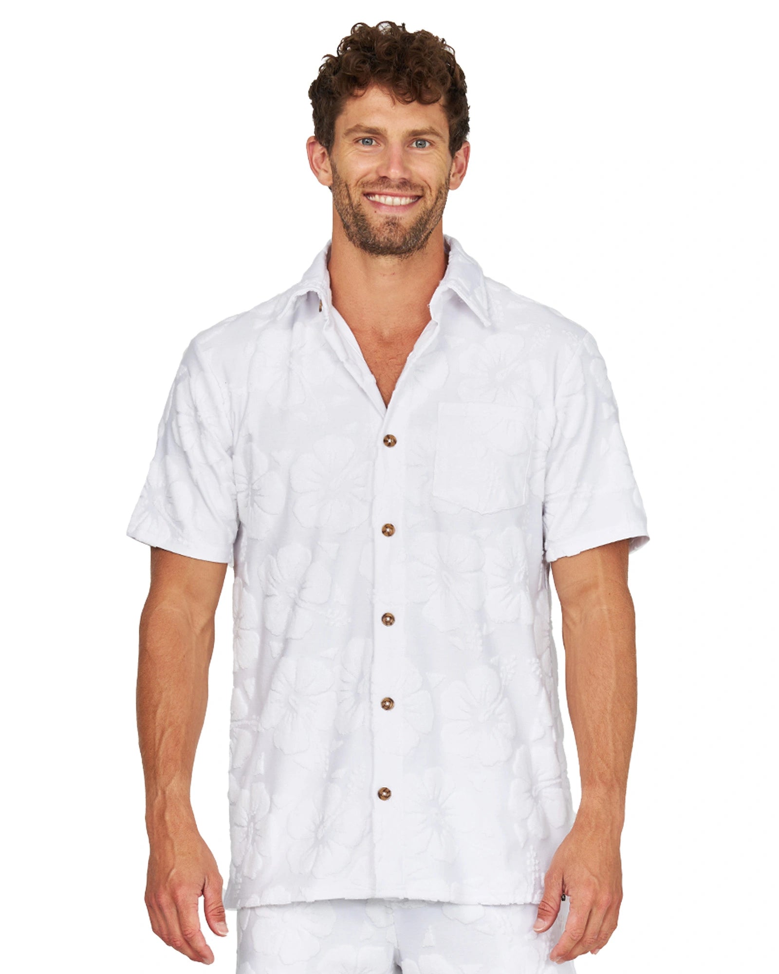 A male model wearing the Okanui Starboard Short Sleeve Shirt in Hibiscus white.