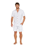 Full body view of a male model wearing the Okanui Starboard Short Sleeve Shirt in Hibiscus white.