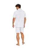 Full body back view of a male model wearing the Okanui Starboard Short Sleeve Shirt in Hibiscus white.