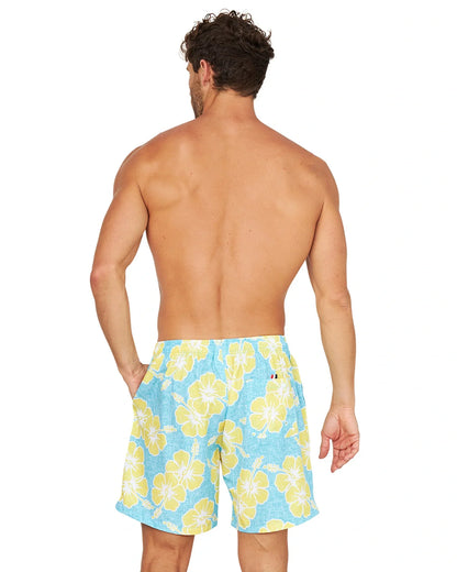 Back view of a shirtless male model wearing the Okanui Way Back When Stretch Swim Short in Aqua Yellow.