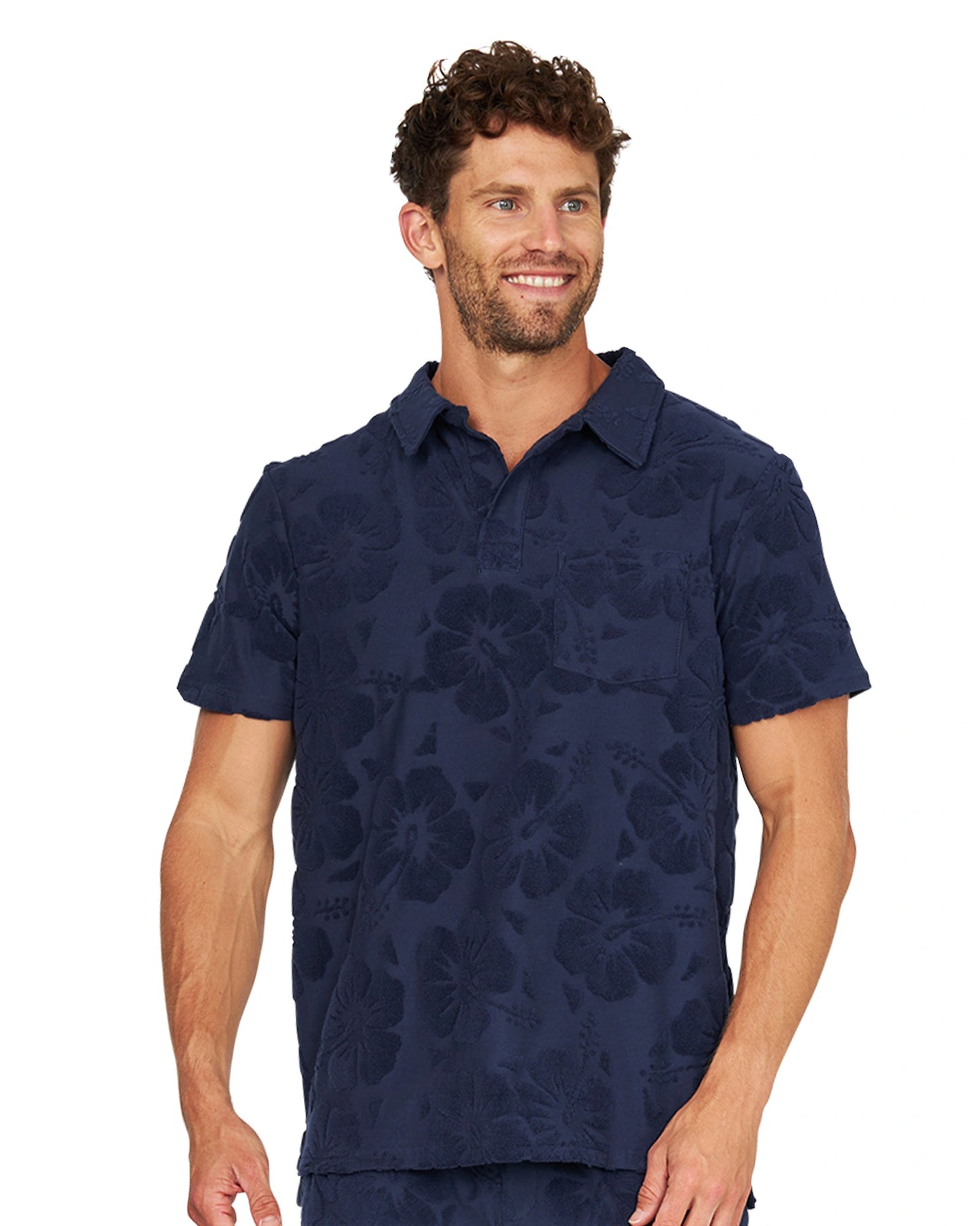 A male model wearing the Okanui Weekend Terry Jacquard Polo in Hibiscus Navy.