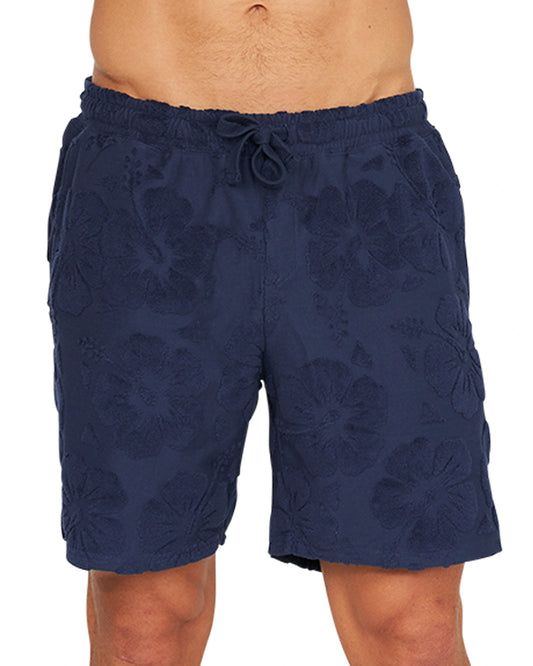 A close up view of the Okanui Weekend Terry Jacquard Walk Short navy colour that features a subtle Hibiscus flower pattern, drawcord and elastic waist.