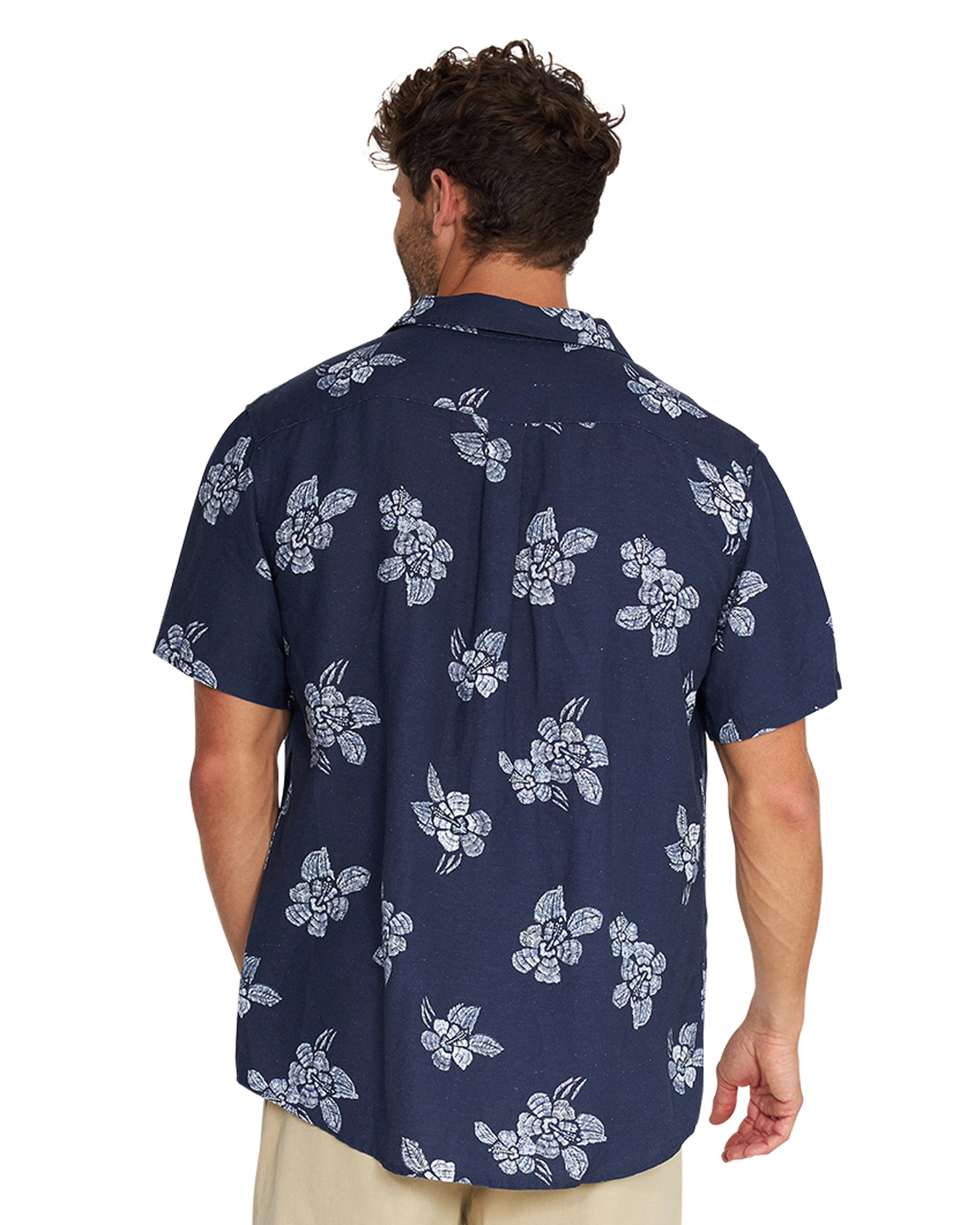 Closer back view of a male model wearing the Okanui Whitewater Aloha Short Sleeve Shirt in navy color.