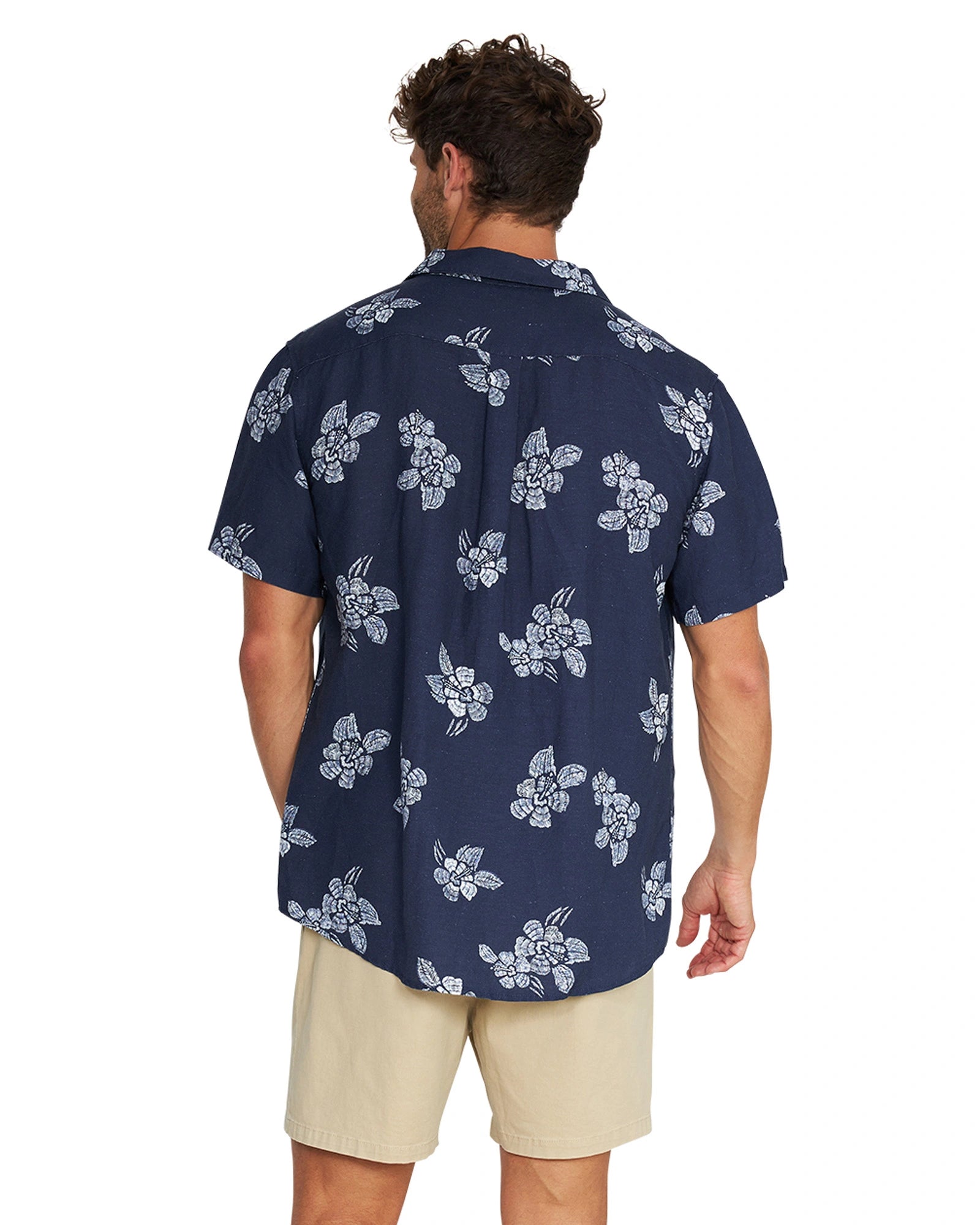 Back view of a male model wearing the Okanui Whitewater Aloha Short Sleeve Shirt in navy color.