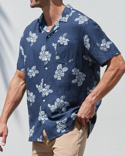 A male model posing candid on the streets wearing the Okanui Whitewater Aloha Short Sleeve Shirt in navy color.