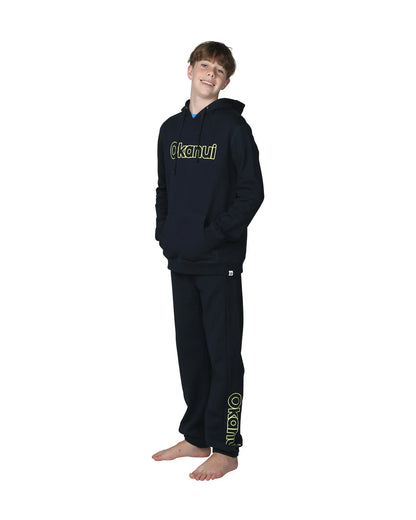 Full body front view of a boy wearing the Okanui Winter Keyline trackies for Kids in Navy color paired with a Navy color Okanui Jacket