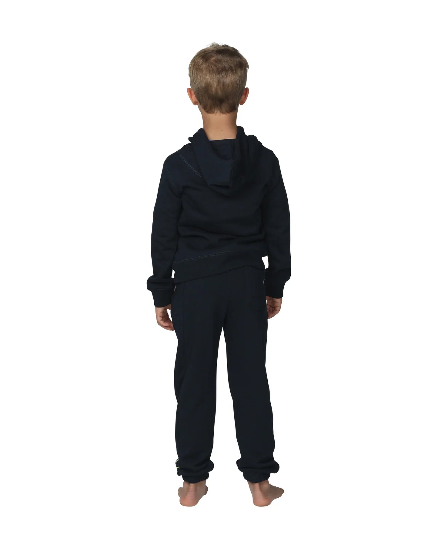 Full body back view of a little boy wearing the Okanui Winter Keyline trackies for Kids in Navy color paired with a Navy color Okanui jacket