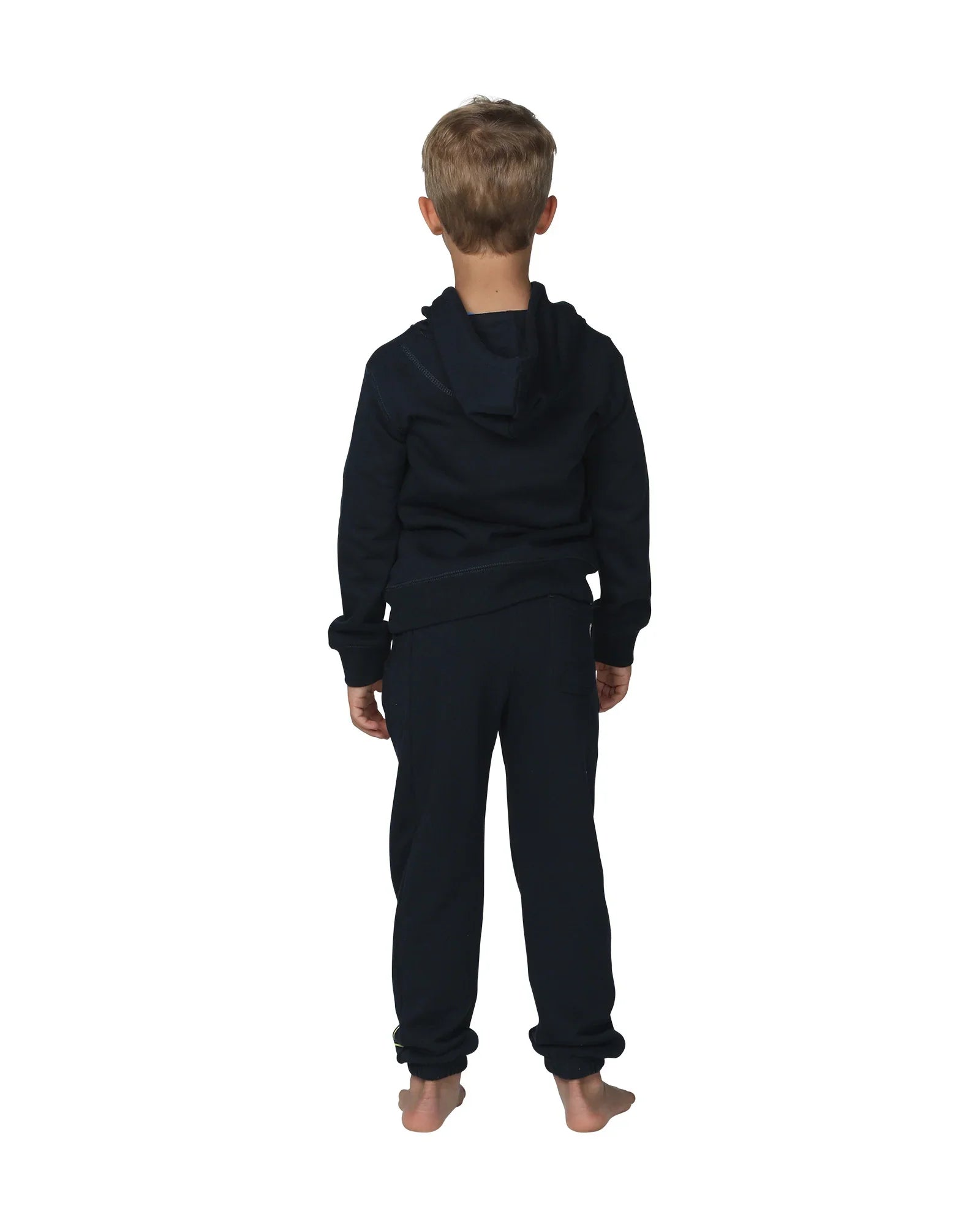 Full body back view of a little boy wearing the Okanui Winter Keyline trackies for Kids in Navy color paired with a Navy color Okanui jacket