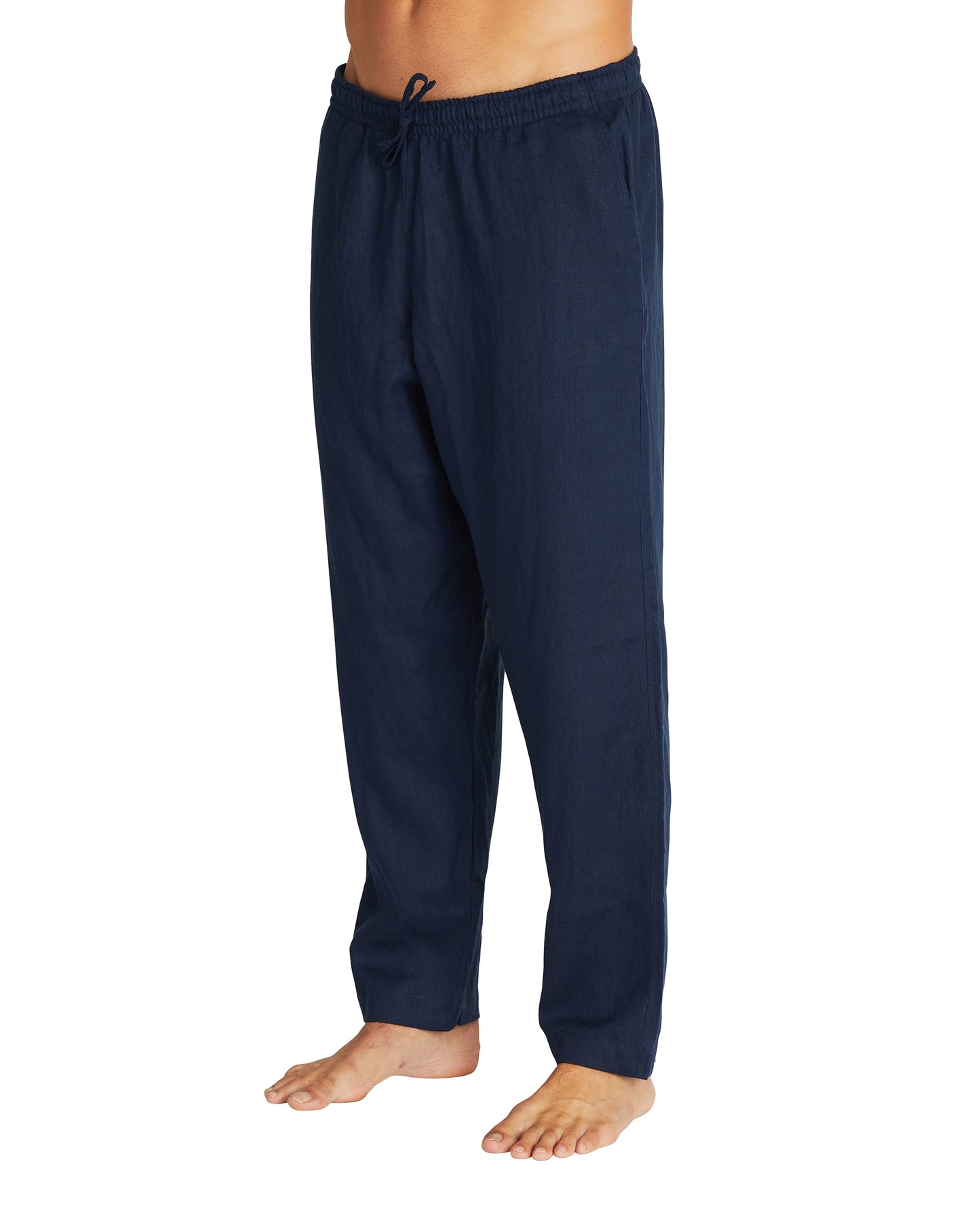 A side view of the Okanui linen pants in navy color with a loose fit.