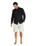 Male model wearing Okanui's linen long sleeve shirt in black colour with linen shorts.