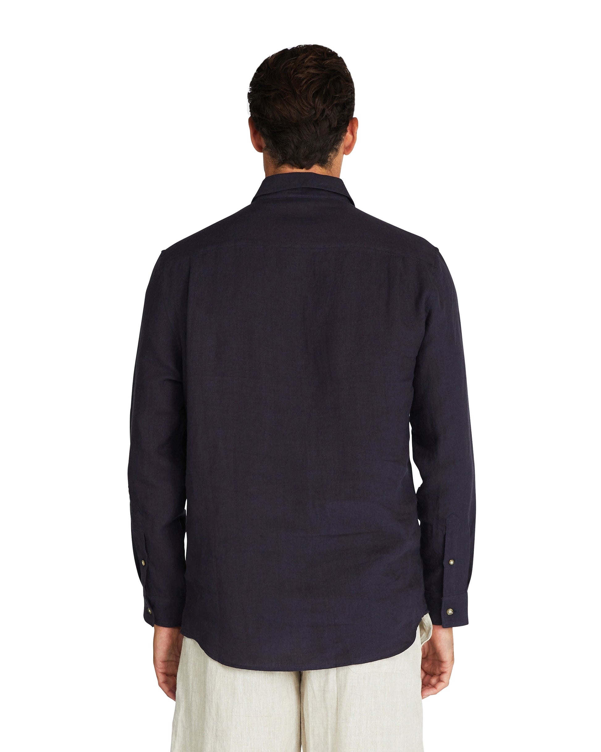 Back view of the side of Okanui Autumn Linen long sleeve shirt in navy.