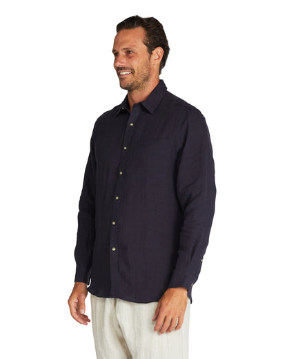 Closer view of the side of Okanui Autumn Linen long sleeve shirt in navy.