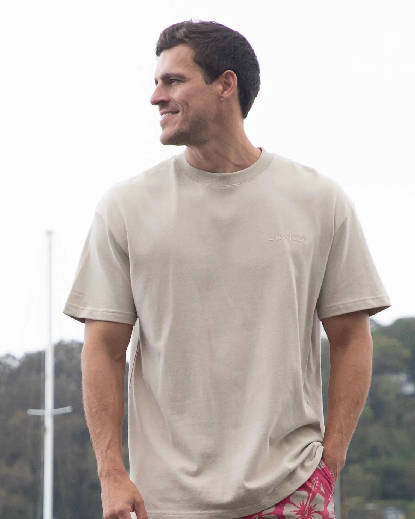 Front view of a male model wearing the Okanui T-shirt Cubist Tee in Washed Stone