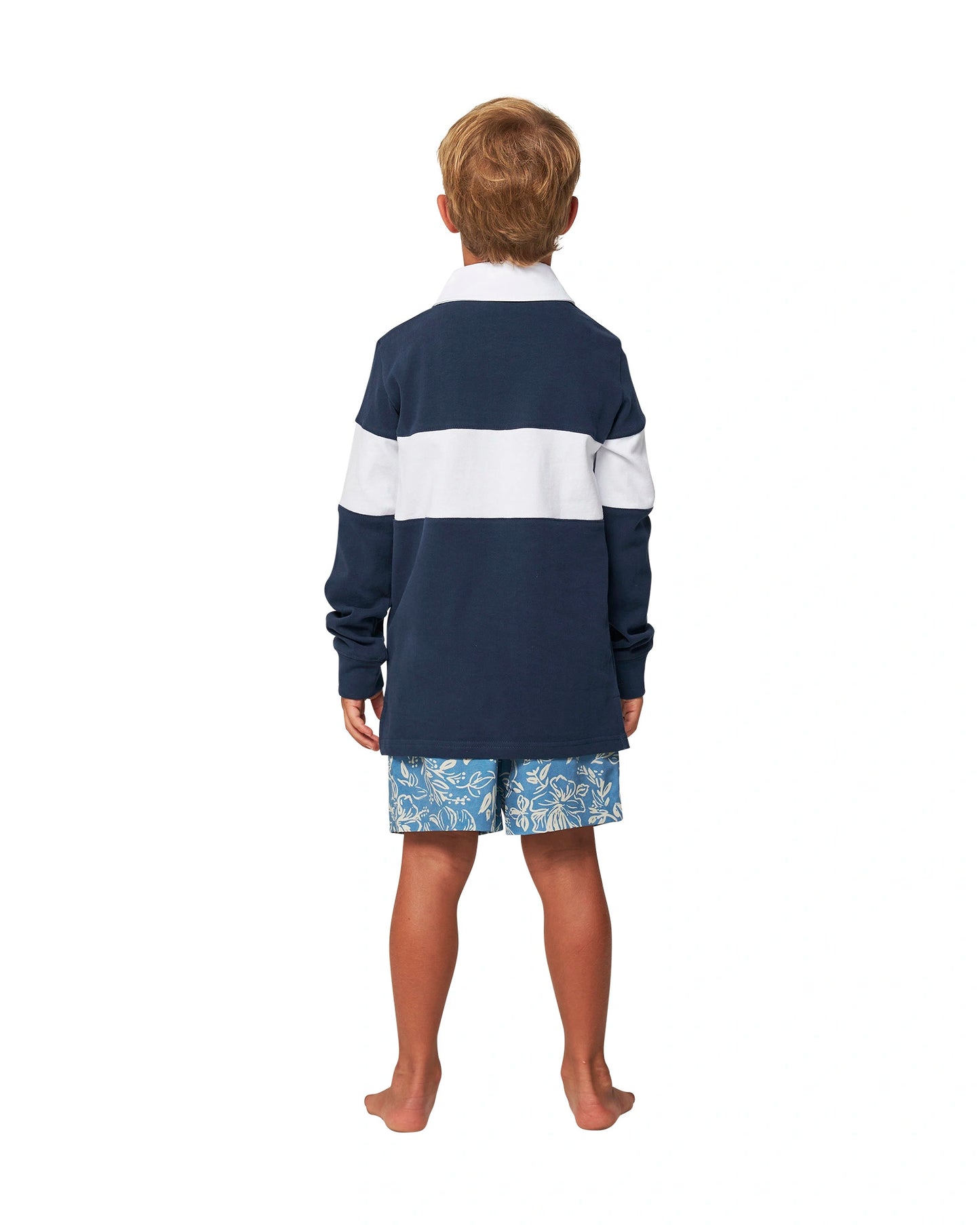 Full body back view of a little  boy wearing the Okanui Heritage Rugby Top and Jumpers in Navy/White