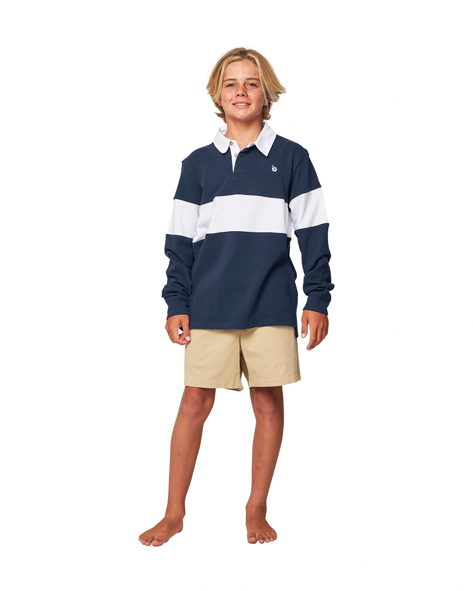 Full body front view of a boy wearing the Okanui Heritage Rugby Top and Jumpers in Navy/White