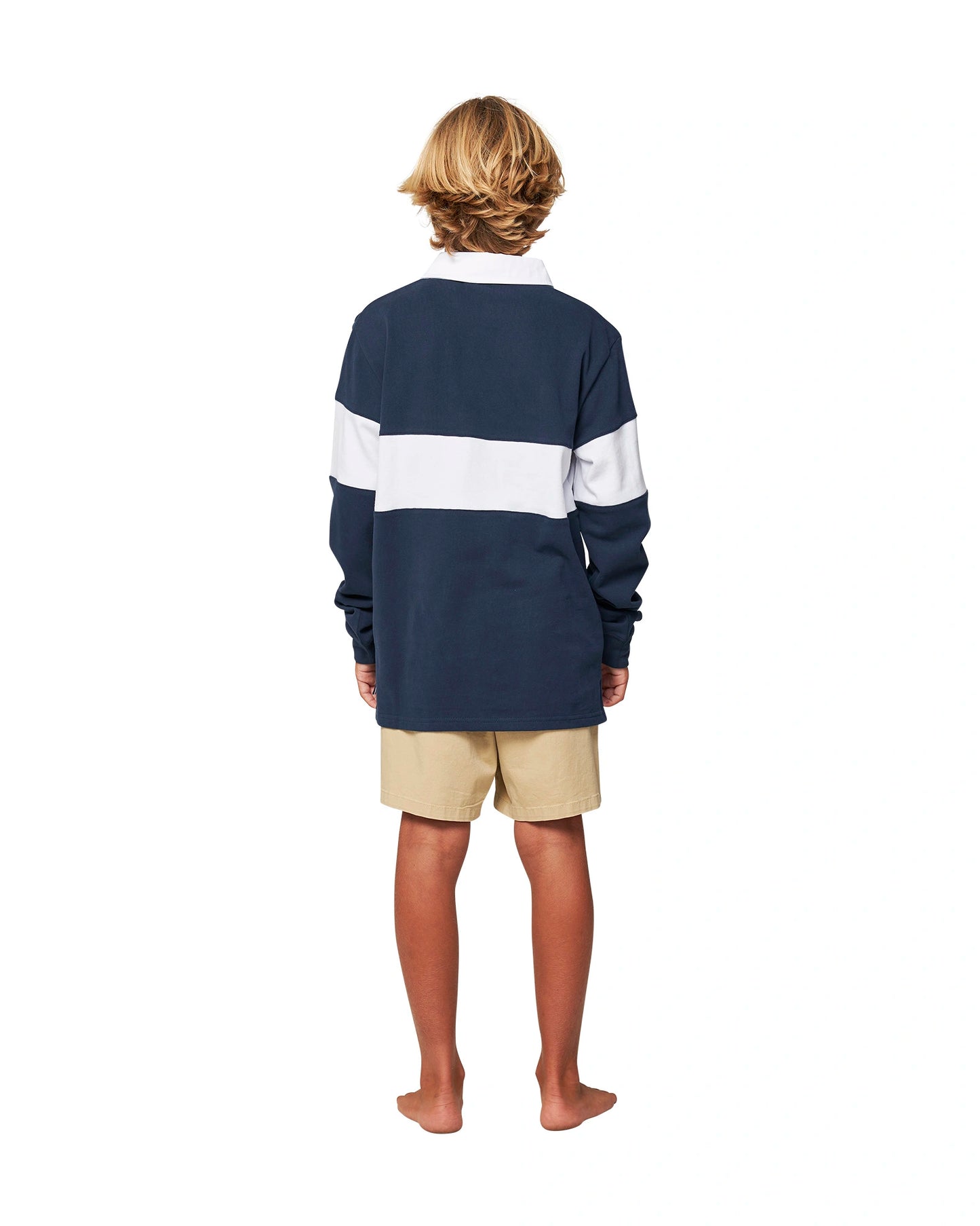 Full body back view of a boy wearing the Okanui Heritage Rugby Top and Jumpers in Navy/White