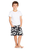 A classic white and black color hibiscus flower short worn with a simple white top shirt. 