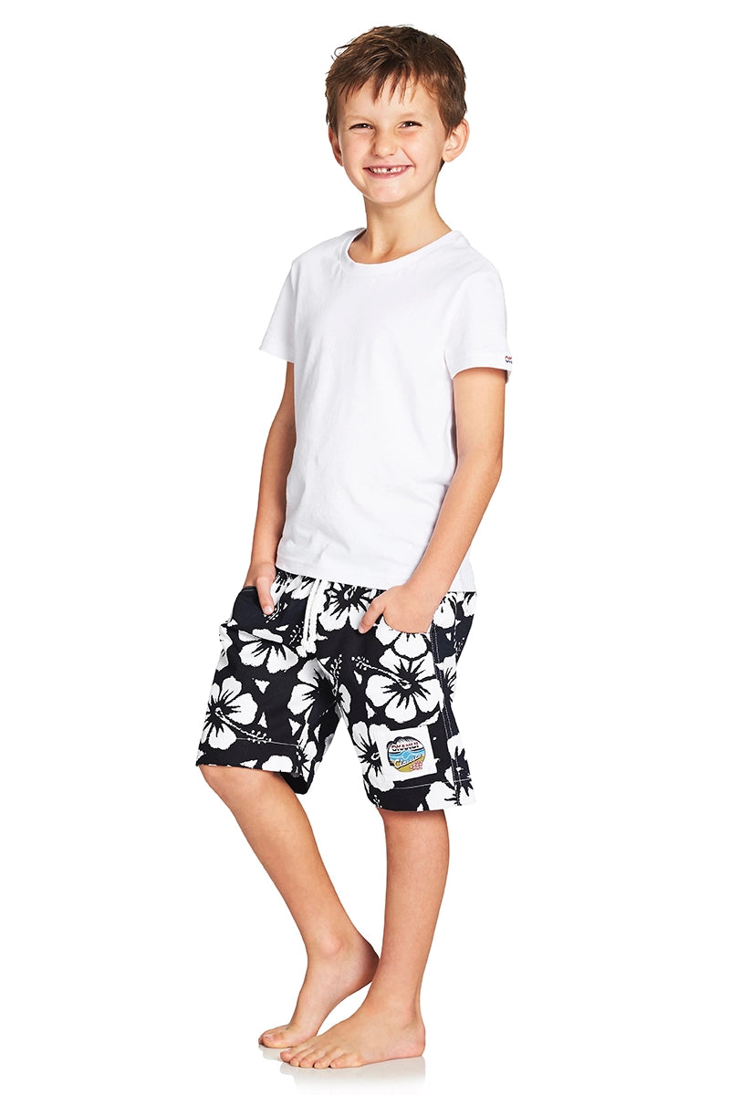 A classic kids short with black and white hibiscus flower showing the side part with a logo in the lower left bottom.