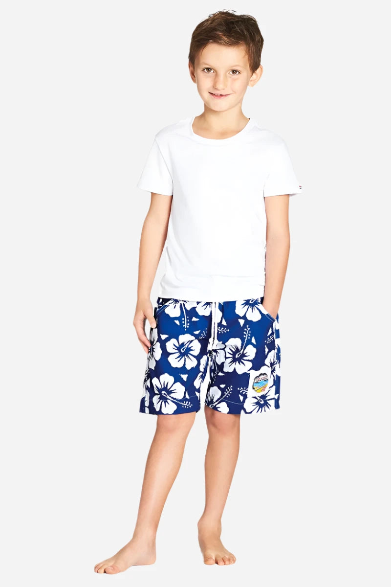 A classic kids white and red color hibiscus flower short worn with a simple white top shirt