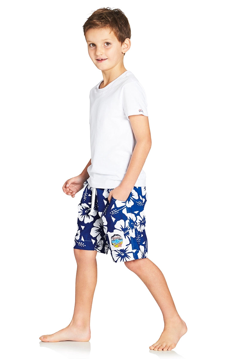 A classic kids short with blue and white hibiscus flower showing the side part with a logo in the lower left bottom.