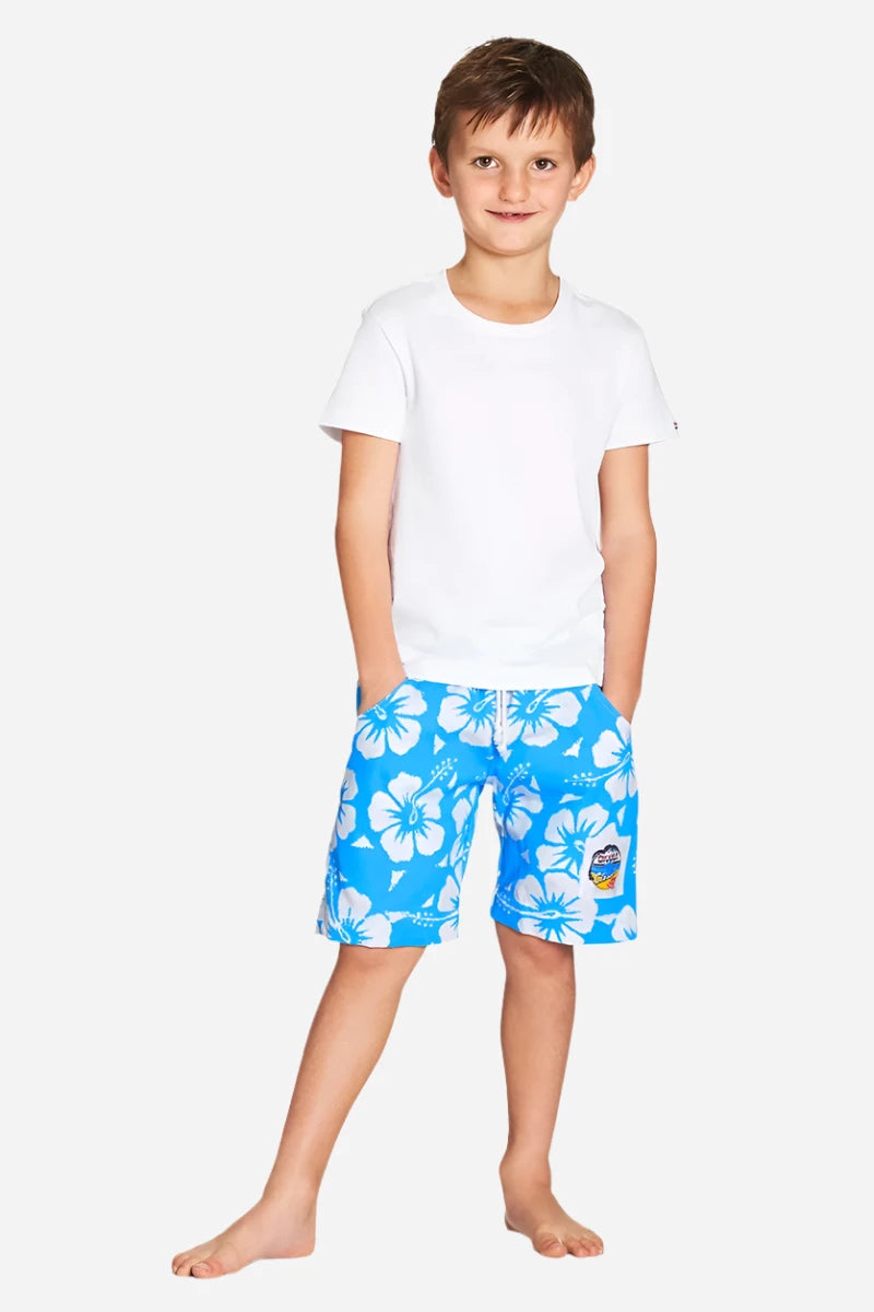 A classic white and sky blue color hibiscus flower short worn with a simple white top shirt. 