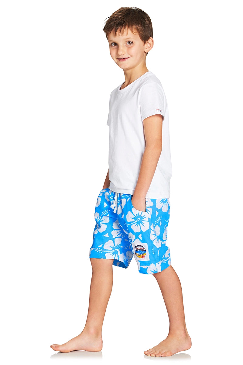 A classic kids short with sky blue and white hibiscus flower showing the side part with a logo in the lower left bottom.