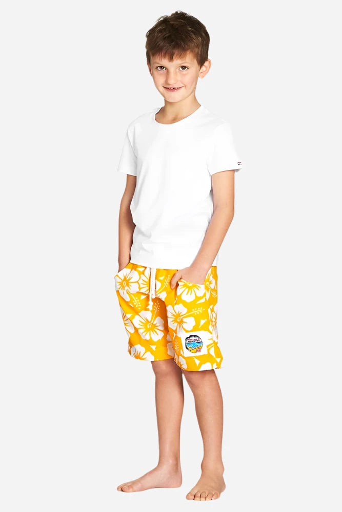 A classic white and yellow color hibiscus flower short worn with a simple white top shirt