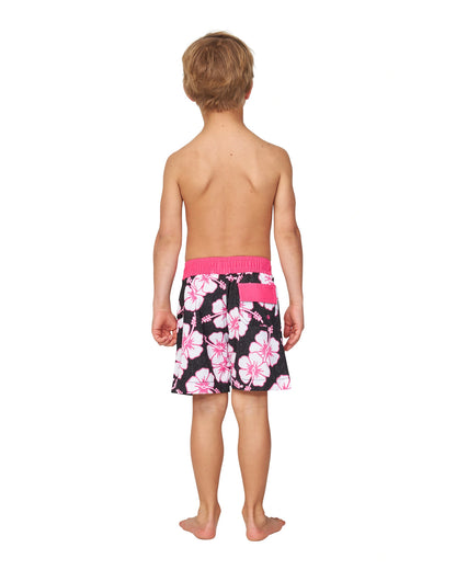 Full body back view of a little boy wearing the Okanui kids boardrider boardshort in Black Pink