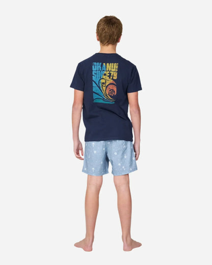Full boy back view of a boy wearing the Okanui navy shirt paired with the Okanui walk shorts for boys in washed denim