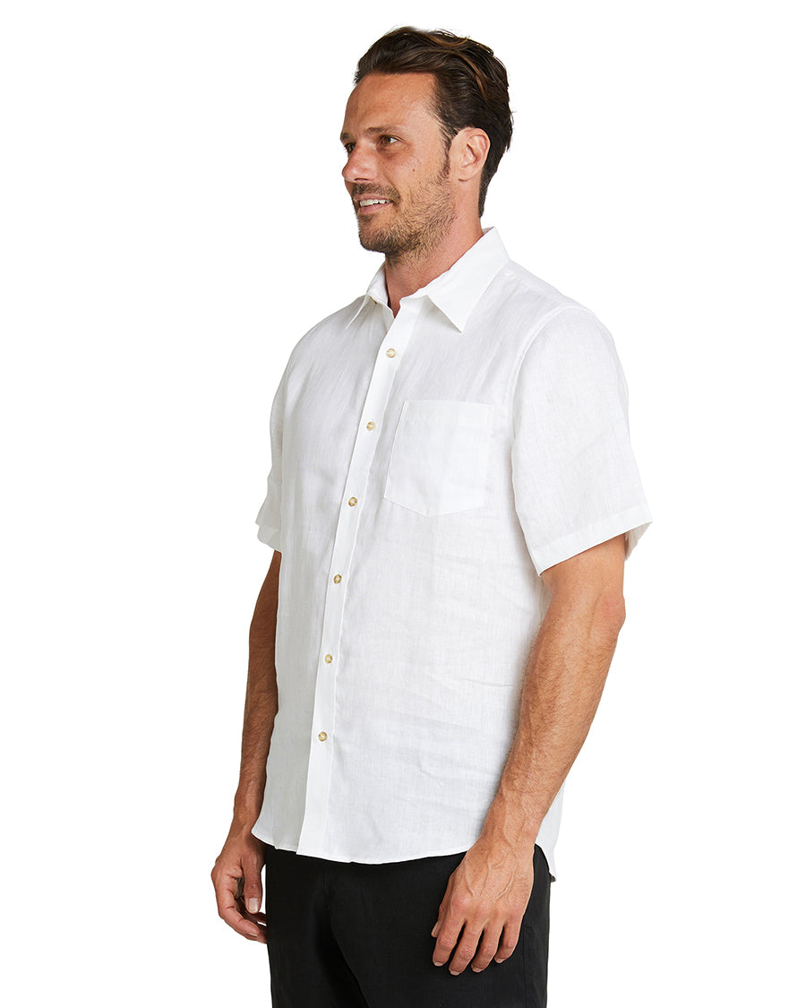 A closer side view of the model wearing the Okanui Linen Short Sleeve Shirt.