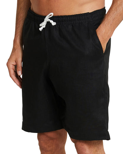 Front view of Okanui Linen walking shorts for men with the hand in the pocket pose of a male model