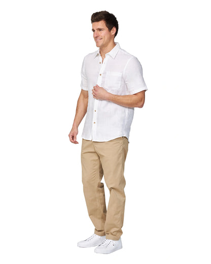 Full-body side view of the Okanui Men's Chino Pants in sand color worn by a model with shirt and shoes.