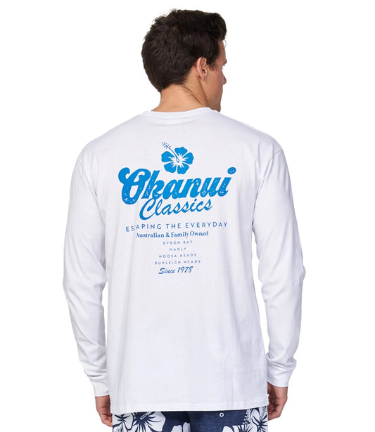 The Okanui Fast Lane Long Sleeve T-shirt as seen from the back worn by a model featuring a bright blue Okanui logo and other blue alphabetical phrases.