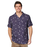 The Okanui Icons Coastal Short Sleeve Aloha shirt worn by a model smiling at the camera.