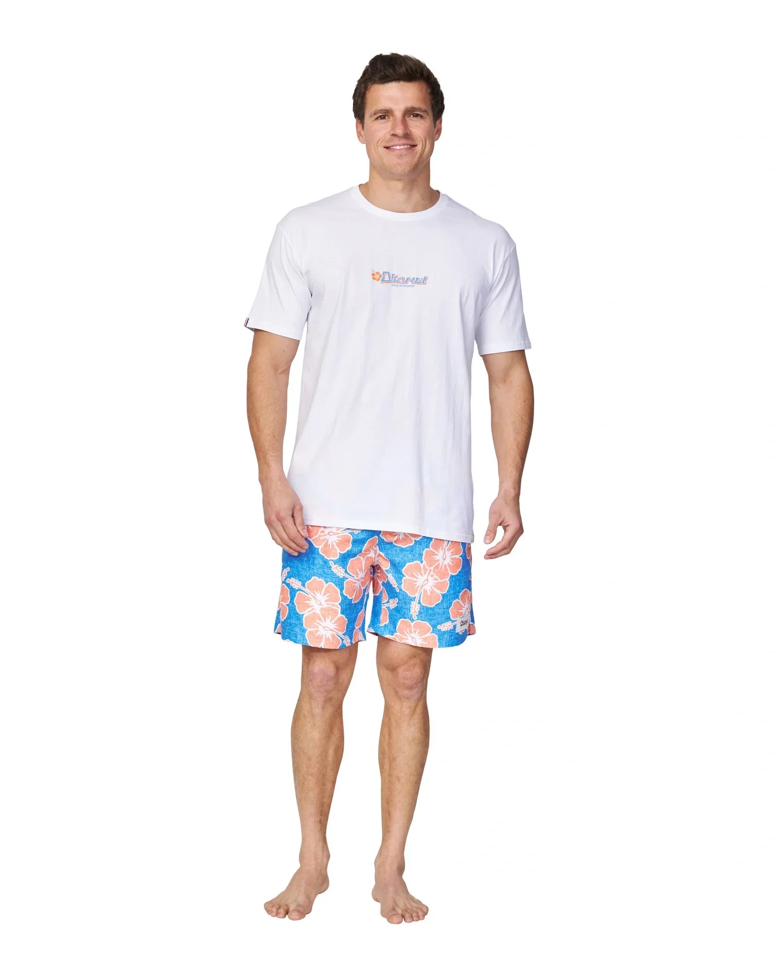 The Okanui Way Back When Swimshorts in Bright Blue/Orange colour paired with a white t-shirt.