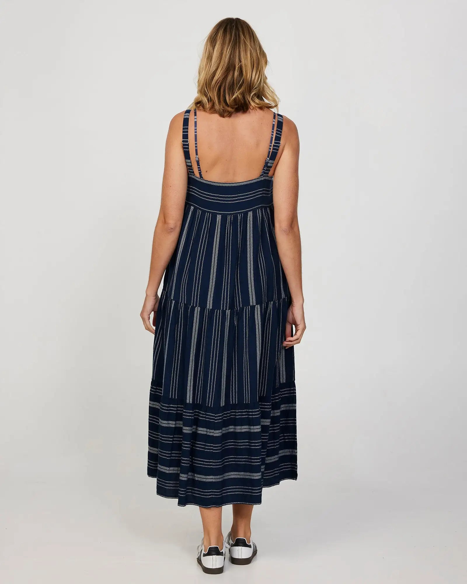 Back view of a female model wearing a long navy Okanui Dress.