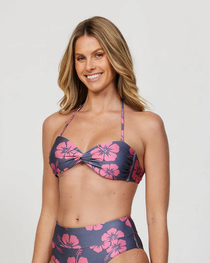 Front view of a smiling female model wearing the Okanui Sundance Bandeau Bikini Swim Top in Hibiscus Iron Pink