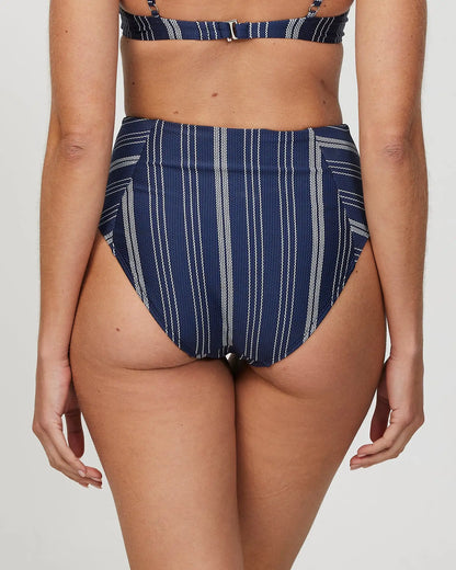 Back view of a female model wearing the Okanui Horizon High waist Bikini Bottom in Navy Stripe