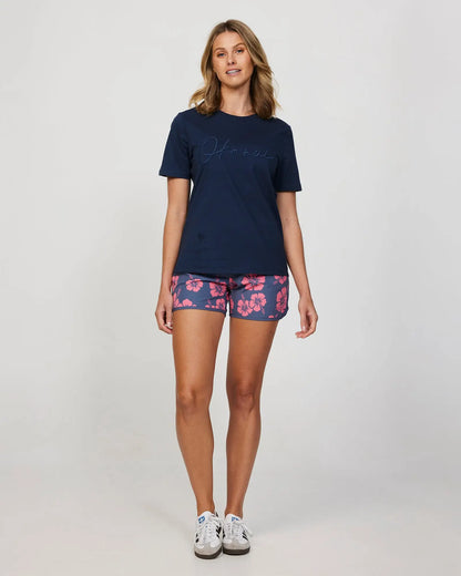 Full front view of a female model wearing a navy Okanui Signature Tee