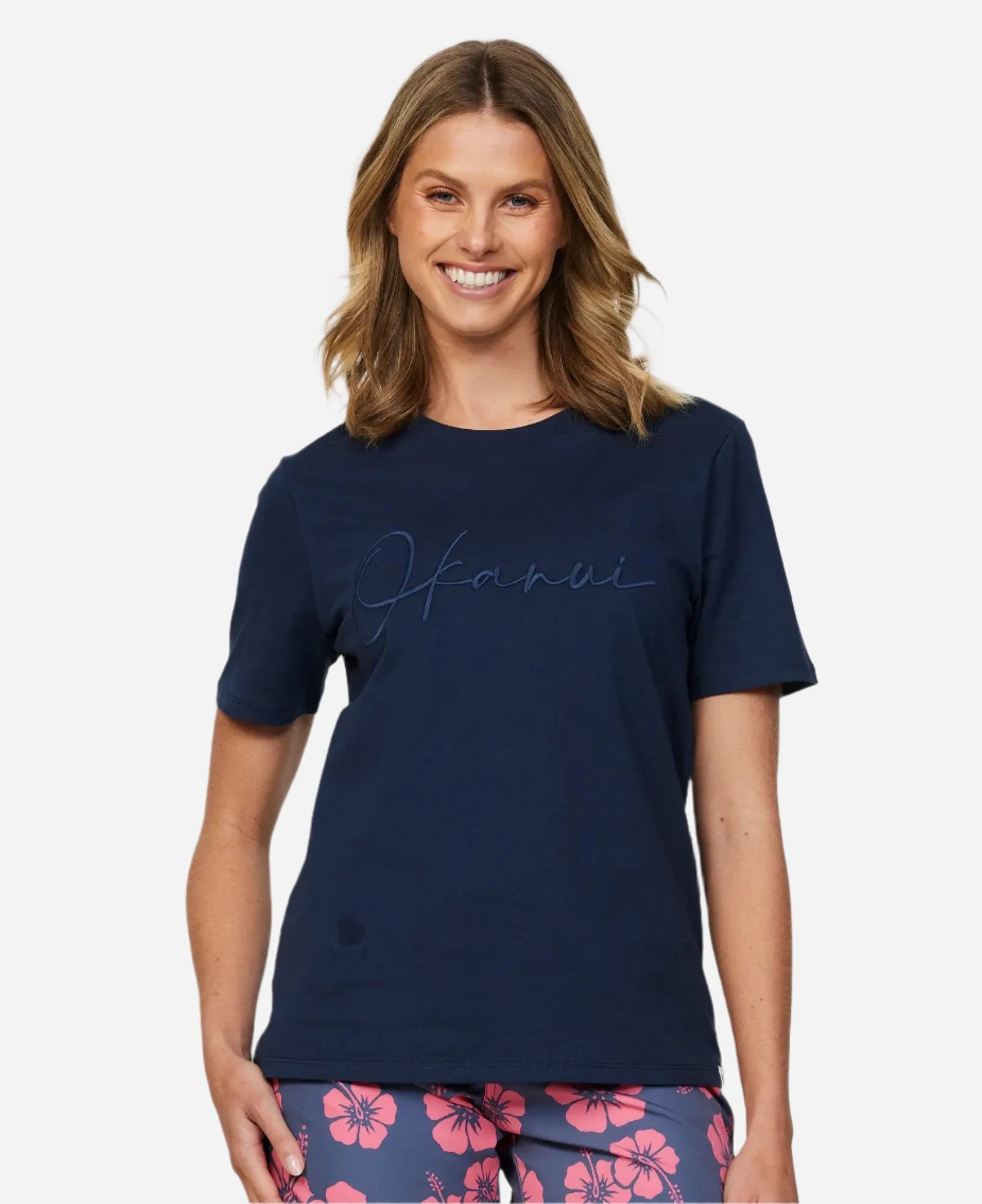 Front view of a female model wearing a navy Okanui Signature Tee