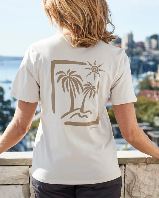 Female model on a terrace wearing a white Okanui View Tee showcasing print on the back.