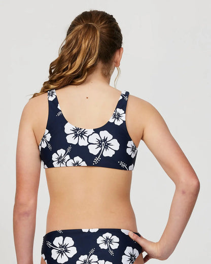 Closeup back view of a girl model wearing the Okanui Crop Bikini Set in Hibiscus Navy